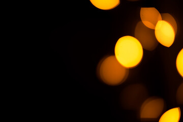 Bright yellow, gold lights, bokeh on black background