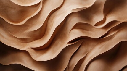 Obraz premium Sandy brown surface showcasing intricate natural waves and flowing textures, evoking a sense of organic movement and depth in its design.