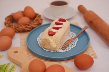 Strawberry cheese cake with cup of coffee on a table.