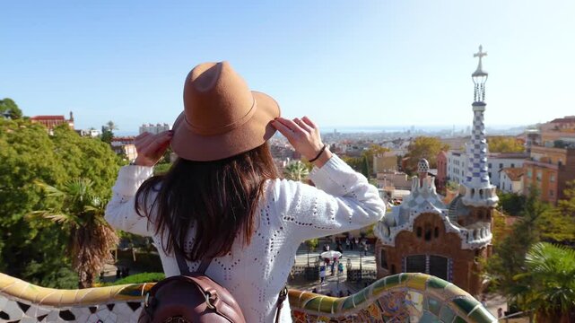 A tourist woman enjoys a sightseeing trip of the famous landmarks at Barcelona, Spain, on a sunny day