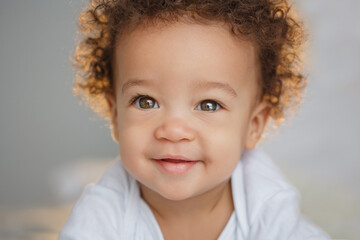Naklejka premium Cute baby with fluffy hair. Pretty boy.