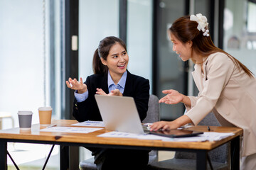 Two asian business women Accounting using calculating income-expenditure and analyzing real estate investment documents data report Financial and tax systems concept.