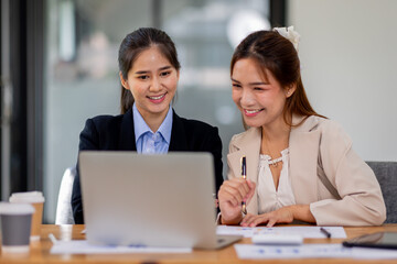 Obraz premium Two asian business women Accounting using calculating income-expenditure and analyzing real estate investment documents data report Financial and tax systems concept.