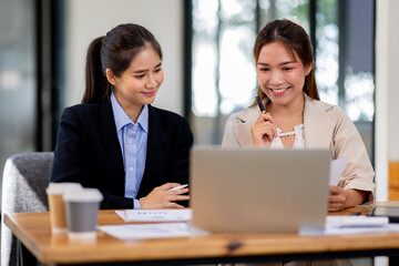 Two asian business women Accounting using calculating income-expenditure and analyzing real estate investment documents data report Financial and tax systems concept.