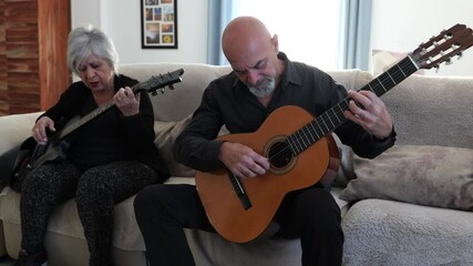 Senior couple practice electric and spanish guitar - Powered by Adobe