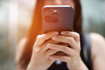 close up of young woman using mobile smart phone