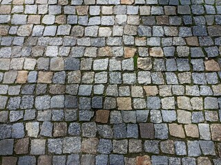 the surface is paved with cobblestones, square stones