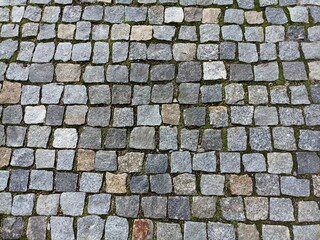 the surface is paved with cobblestones, square stones