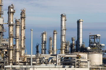 Industrial refinery complex with lots of pipes and smokestacks