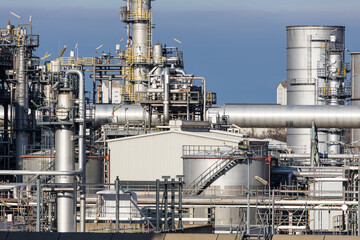 Industrial refinery complex with lots of pipes and smokestacks