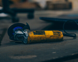 yellow metal cutter with a wheel