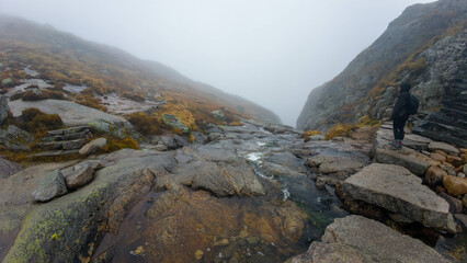 Hiker on Foggy Mountain Path