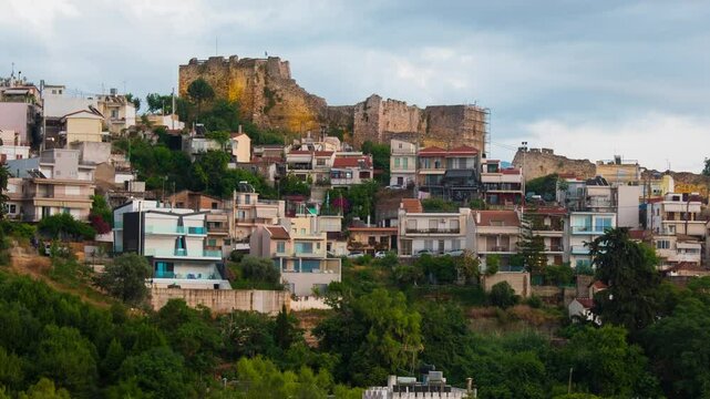 Patras, Greece. View of old houses and a castle in Patras, Greece. Time-lapse at sunset, panning video