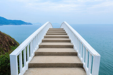 Fototapeta premium serene staircase leads to ocean, surrounded by nature beauty