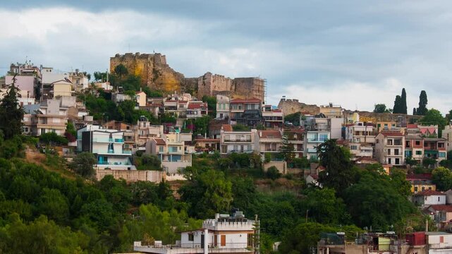 Patras, Greece. View of old houses and a castle in Patras, Greece. Time-lapse at sunset, zoom in