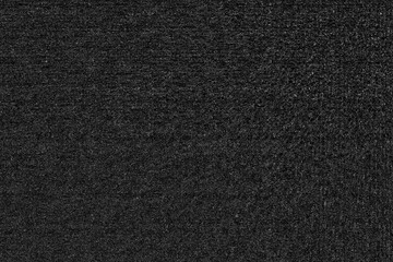 Black asphalt road background. The dark grey texture of the tarmac with cracks, Grungy volcano rock.