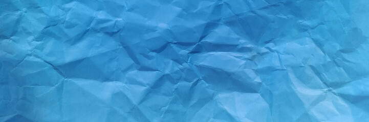 Crumpled blue paper background texture. Blue crumpled and creased paper poster texture background