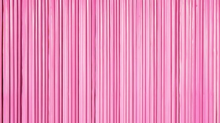 Obraz premium A vibrant pink curtain featuring vertical stripes, creating a playful and cheerful atmosphere.