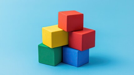 Obraz premium A colorful stack of toy blocks arranged on a blue background, showcasing vibrant primary colors and a playful design.