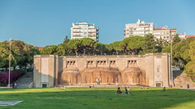 Timelapse hyperlapse of Fonte Luminosa fountain in Alameda Park, Lisbon. Iconic landmark celebrating water supply to the city's eastern district. Residential buildings in view. Portugal