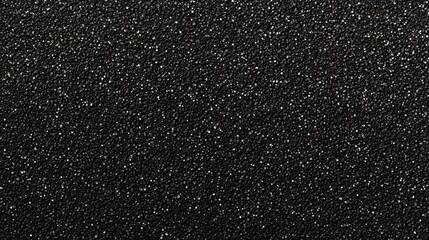 Close-up of a textured black surface with shimmering specks, creating a sophisticated and elegant visual effect.