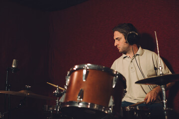 Fototapeta premium Drummer playing dynamic rhythms during a recording session