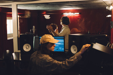 Sound engineer and percussionist during a studio recording session