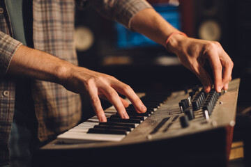 Fototapeta premium Close-up. A musician plays the keyboard in a recording studio.