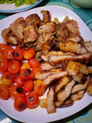 Grilled beef with grilled tomatoes on a plate