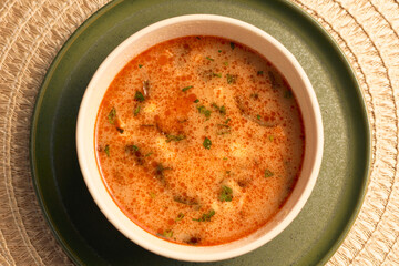 Creamy Red Soup Garnished with Herbs