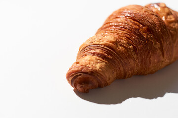 Golden Croissant on White Background