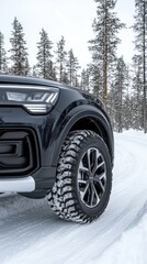 Naklejka premium White winter tires grip the snowy road, with soft forest outlines in the background, showcasing a serene, minimalistic winter landscape
