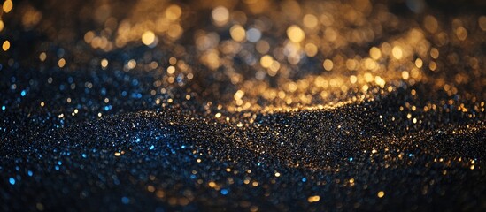 Abstract shimmering glitter backdrop in gold black and blue tones with a festive holiday theme ideal for celebrations or party invitations