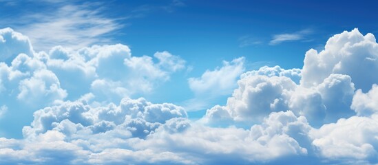 Serene blue sky with fluffy white clouds creating a peaceful and textured backdrop for various design projects.