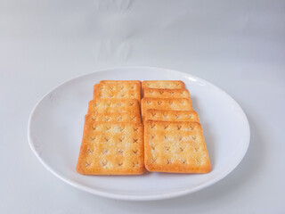 Sugar coated biscuits, also known as malkist, sweet and crispy. Served on white plate