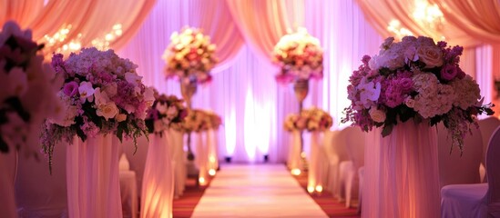 Elegant wedding decor with floral arrangements draped curtains and soft lighting setting a romantic atmosphere for beachside or banquet hall events