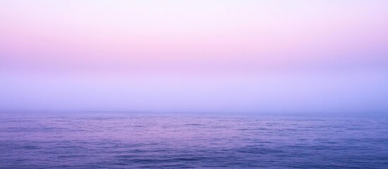 Tranquil seascape at dusk with soft pastel hues reflecting on calm waters under a serene twilight sky