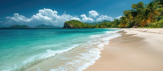 Obraz premium Scenic tropical beach with pristine white sand and vibrant turquoise waters under a blue sky with fluffy clouds and lush green foliage.