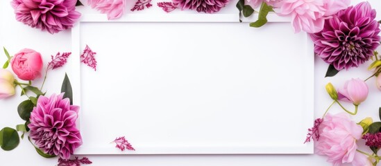 Elegant floral arrangement with pink blooms surrounding a blank photo frame on a white background ideal for invitations or announcements.