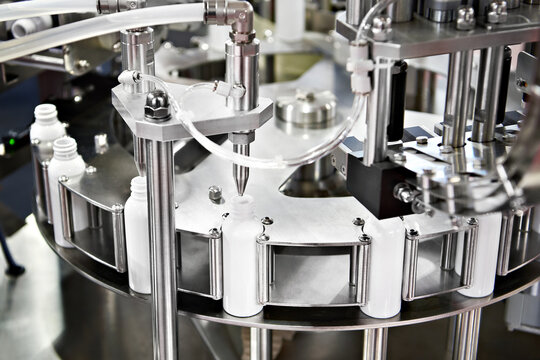 Machine for filling liquids into plastic tubes - Powered by Adobe