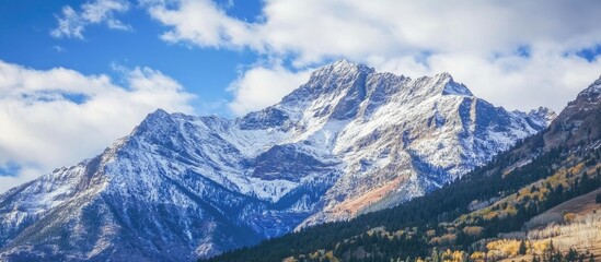 Scenic mountain landscape with majestic snowy peaks under a clear blue sky highlighting nature's beauty and tranquility.