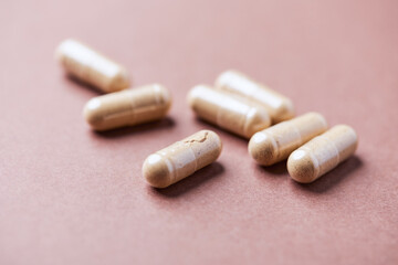 Korean Ginseng capsules. Concept for a healthy dietary supplementation. Bright paper background. Close up.	