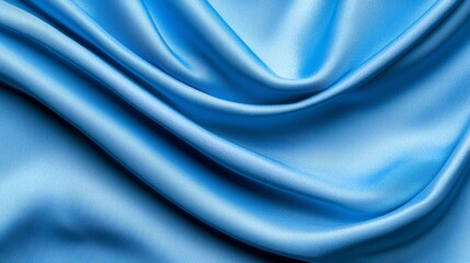 Obraz premium a close up of a blue satin fabric with a smooth, glossy texture The fabric is a deep, vibrant blue color and has a subtle sheen that catches the light The folds a