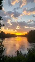 Fototapeta premium Breathtaking sunset over a tranquil river landscape.