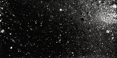 Obraz premium Black and white speckled texture with scattered white dots on dark background. Abstract spray paint or snow effect overlay with gradient fade and particle dispersion. 8k banner with copy space