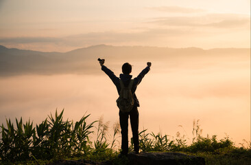 At sunrise, holiday maker embraced adventurous lifestyle of hiking through fog-covered mountains,...