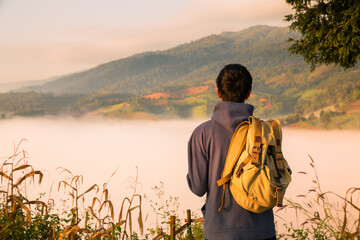 At sunrise, holiday maker embraced adventurous lifestyle of hiking through fog-covered mountains,...
