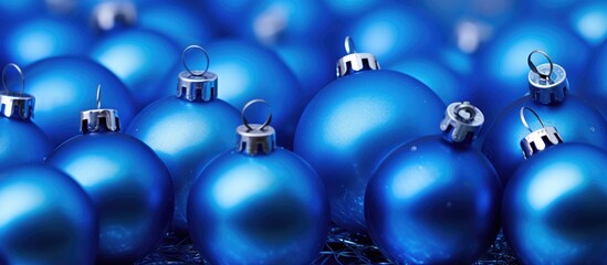 Blue Christmas ornaments arranged closely together highlighting their shiny texture and festive appeal for holiday decoration themes.