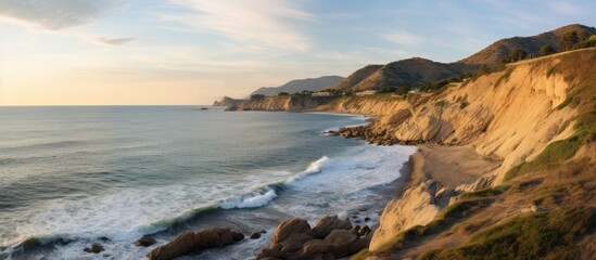 Obraz premium Scenic coastline of Castellon province at sunset with rocky cliffs and gentle waves