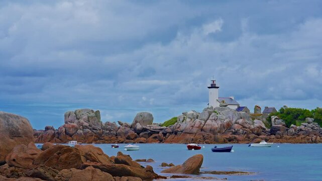 Small motor boats and yachts anchored in the bay, Phare de Pontusval, Brittany, France. Timelapse